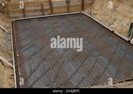 Reinforcing steel ready for to cover with concrete in an excavated pit Stock Photo
