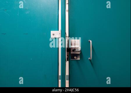 Metal public bathroom stall lock Stock Photo - Alamy