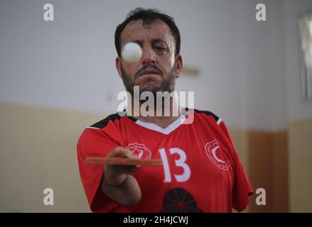 Gaza. 3rd Nov, 2021. Palestinian Abdel Qader Abu Libda, born with a disability in both hands, plays table tennis at a sports club in the southern Gaza Strip city of Rafah, on Nov. 3, 2021. Credit: Khaled Omar/Xinhua/Alamy Live News Stock Photo