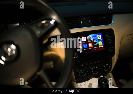 Luxury car interior at night with dashboard computer showing on display Apple CarPlay Stock Photo