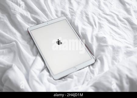 Odessa, Ukraine, September 16, 2020: Top view of white tablet pc with blank desktop white screen on a cozy white bed at home Stock Photo