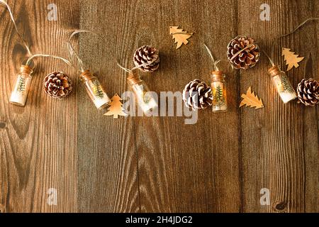 Concept - Christmas wood background with lights and tree with copy space, flat lay Stock Photo