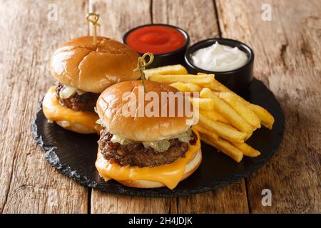 Butter burgers are hamburgers topped with butter either directly on the bun close-up on the wooden table. horizontal Stock Photo