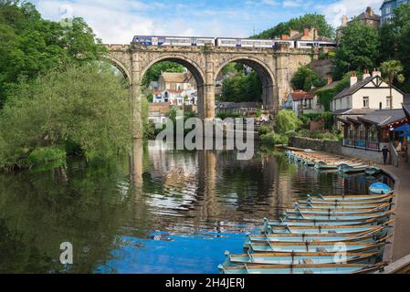 Knaresborough railway bridge, view in summer of a train crossing the historic railway viaduct spanning the River Nidd in Knaresborough, Yorkshire UK Stock Photo