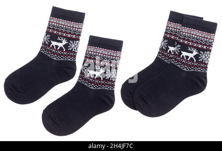 Pair of blue nordic socks with deer and snowflake geometric ornament isolated on a white background Stock Photo