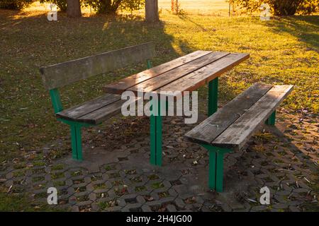 wooden table and bench set for camping and eating and resting abandoned scene in the autumn season Stock Photo