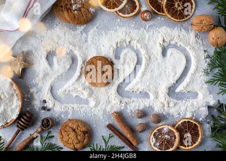 Flour New Year background. Christmas tree branches, gingerbread cookies,  spices and baking supplies on black wood background. Christmas, New Year  gree Stock Photo - Alamy