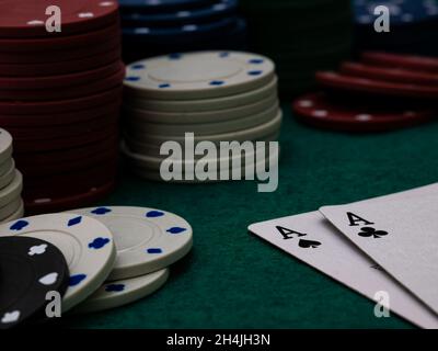 poker game table, two aces with stack of playing chips on the green table Stock Photo
