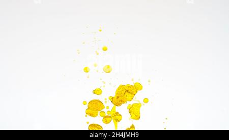 Oil drops isolated. Golden liquid drops of oil in water on a white background. Food or cosmetics component. High quality photo Stock Photo