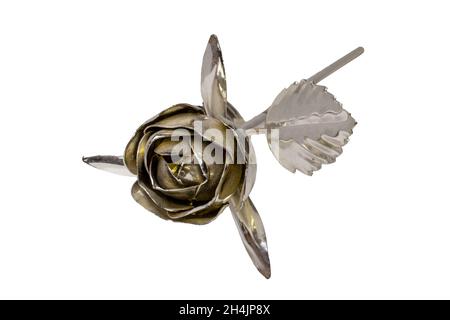 Macro shot of a gold and silver shining handmade wrought iron rose flower isolated on a white background. The focus is on the flower head. Stock Photo