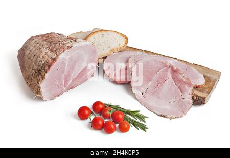 italian roasted ham sliced on a cutting board on white background with tomatoes Stock Photo