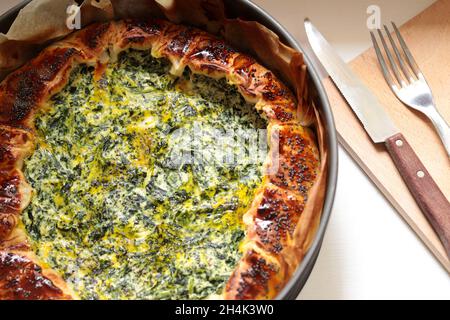 Homemade savory pie with ricotta, spinach and eggs. Directly above. Stock Photo