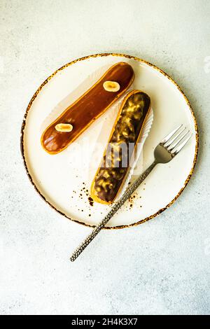 Overhead view of two chocolate eclairs on a plate Stock Photo