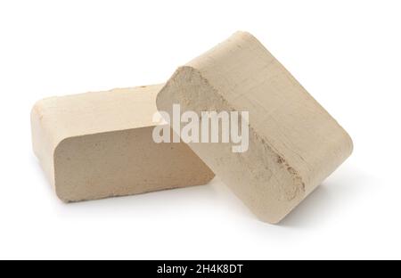Two pressed sawdust fuel briquettes isolated on white Stock Photo