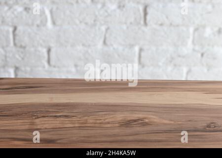Empty wooden table top over white brick wall background Stock Photo