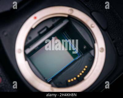A shot of the CMOS sensor inside of a DSLR camera. Low key. Close up. Stock Photo