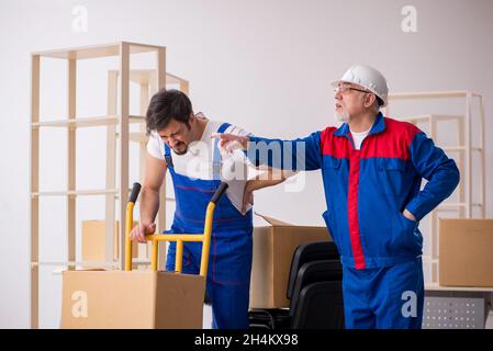 Two professional movers doing home relocation Stock Photo