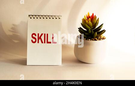 notepad with a mark in the center Skills on a white background with a cactus Stock Photo