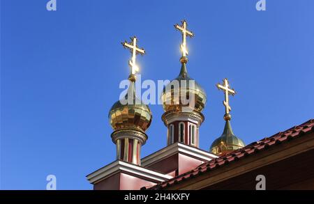 Three Orthodox crosses against the background of a blue summer sky Stock Photo