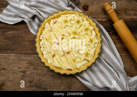 Step 1. Before baking. Homemade open apple pie. Tart with cottage cheese and stars. Pie for July 4th. Patriotic food for Independence Day. Wooden background. Top view. Stock Photo