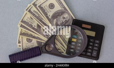 Calculator, money, pen and empty lined paper to white a shopping list. Stock Photo