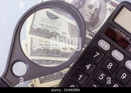 Calculator, money, pen and empty lined paper to white a shopping list. Stock Photo