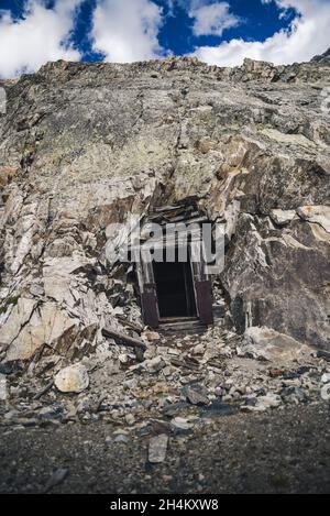 An opening in the side of a mountain from a mine Stock Photo