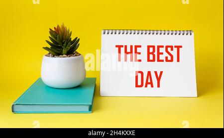 Best day text written on notepad and yellow background. Stock Photo
