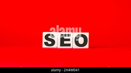 SEO text on wooden cubes and red background Stock Photo