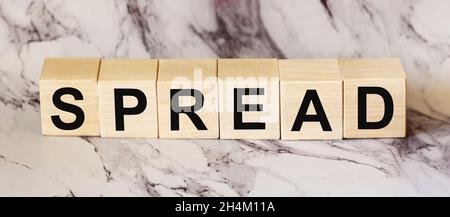Spread, a word written on a wooden block. Spread the word text on the table, concept. Stock Photo