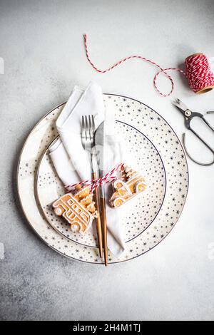 Minimalistic table setting for Christmas dinner on white concrete table Stock Photo