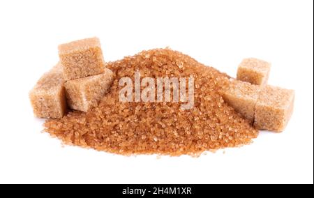Brown sugar isolated on white background. Heap of cane sugar crystals and sugar cubes. Stock Photo