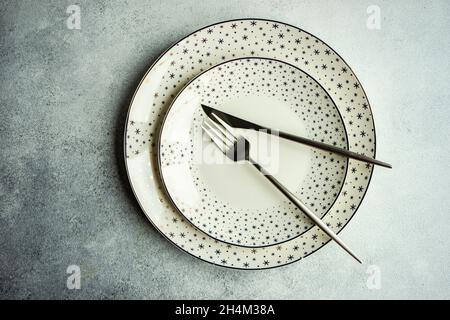 Minimalistic table setting for Christmas dinner on white concrete table Stock Photo