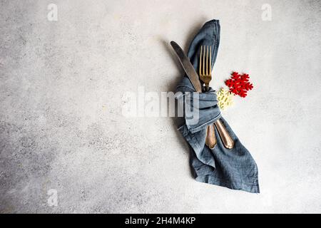 Minimalistic table setting for Christmas dinner on white concrete table Stock Photo