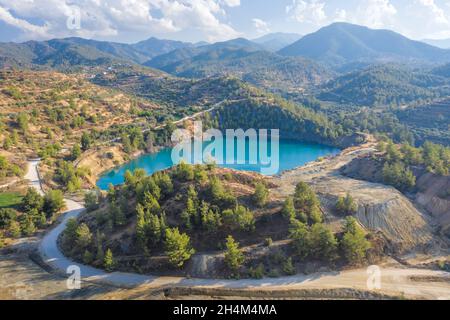 Memi lake in open pit of abandoned pyrite mine in Xyliatos, Cyprus. Ecological restoration and reforestation of old mining area
