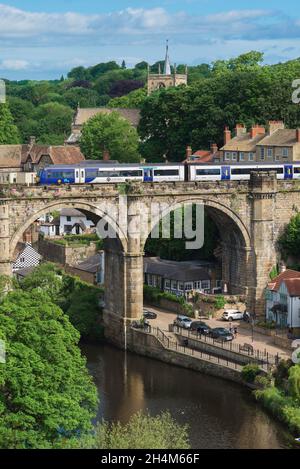 Knaresborough, view in summer of a train crossing the historic railway viaduct spanning the River Nidd in Knaresborough, North Yorkshire, England, UK Stock Photo