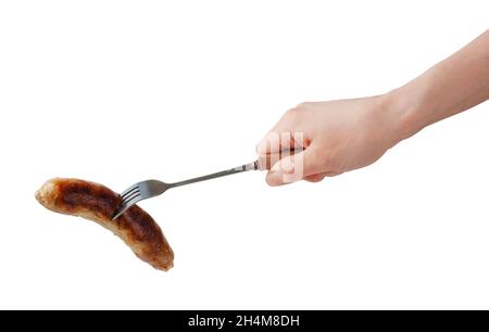Hand holding barbecue fork BBQ sausage isolated on a white background. Stock Photo