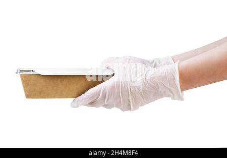 Courier wearing medical gloves holding paper box lunch isolated on a white background. Contactless delivery service in quarantine coronavirus pandemic Stock Photo