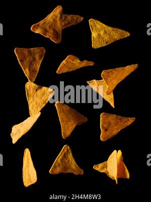 Flying mexican nachos chips, isolated on black background Stock Photo