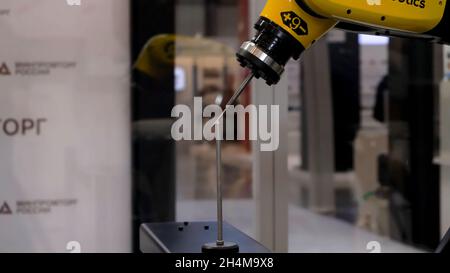 Robot exhibition with an Industrial welding robot moves and demonstrates its accuracy. HDR. Manufacturing, engineering, ai, technology concept Stock Photo