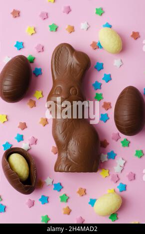Easter chocolate bunny and eggs on a pink background Stock Photo