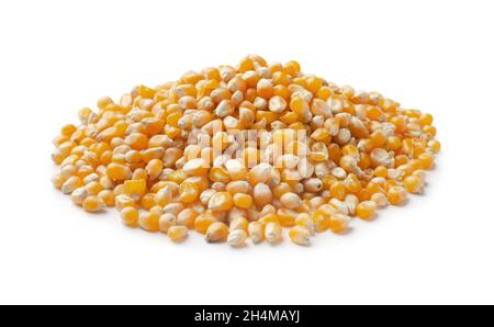 Heap of raw popcorn grains isolated on white background. Dry yellow corns seeds or sweetcorn kernels for popcorn cooking Stock Photo