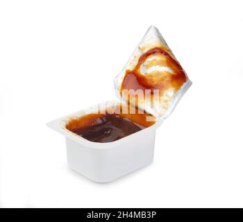 Open BBQ fast food dip packet isolated on white. Dirty cover. Take out container. Stock Photo