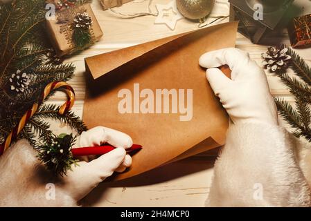 https://l450v.alamy.com/450v/2h4mcp0/the-hands-of-santa-claus-write-a-letter-with-new-year-greetings-festive-christmas-background-2h4mcp0.jpg