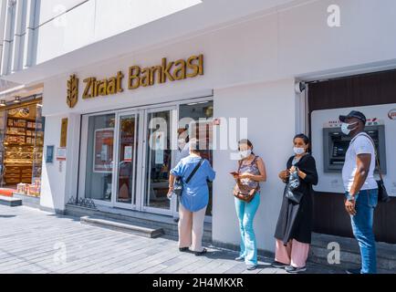 Beyoglu, Istanbul, Turkey - 08.03.2021: state owned Turkish Ziraat Bank costumers masks standing waiting in line to be called because of corona precau Stock Photo