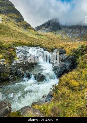 A waterfall on the Allt na Dunaiche river below the mountain slopes of Blaven in the Black Cuillin on the Isle of Skye, Scotland, UK Stock Photo