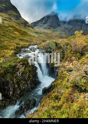 A waterfall on the Allt na Dunaiche river below the mountain slopes of Blaven in the Black Cuillin on the Isle of Skye, Scotland, UK Stock Photo