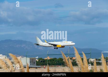 Vueilng holiday flight jet aircraft landing at  Palma Mallorca Airport against blue sky Stock Photo