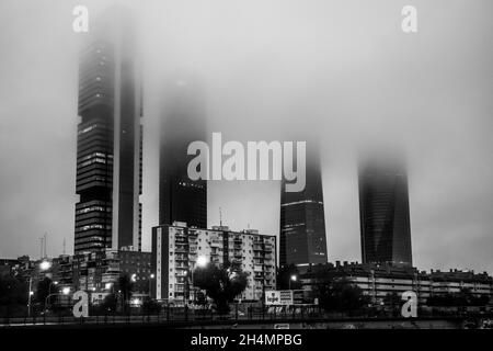 The Cuatro Torres Business Area with the four towers surrounded by fog in the morning as seen  from Chamartin railway station, in Madrid, Spain. Stock Photo