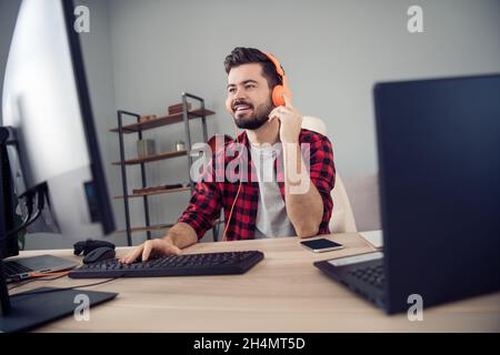 Portrait of attractive trendy cheery focused guy writing code e-mail script html at office workplace workstation indoor Stock Photo